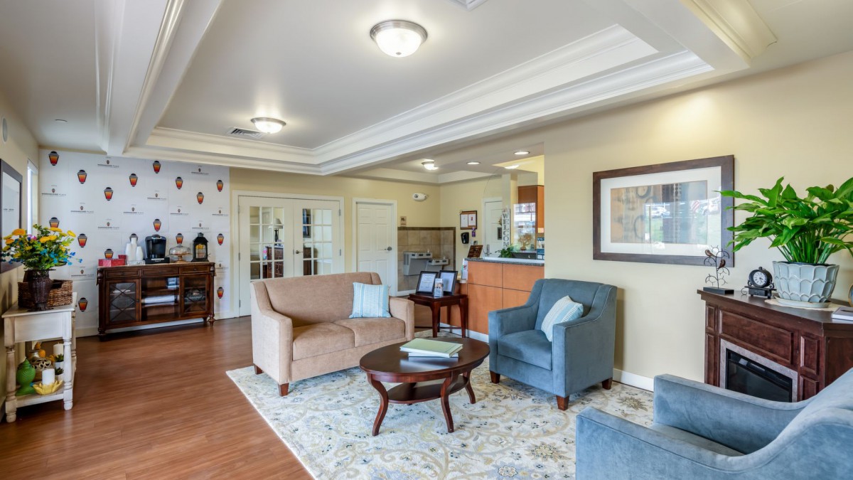 A cozy and stylish living room featuring a sofa, armchair, and coffee table.