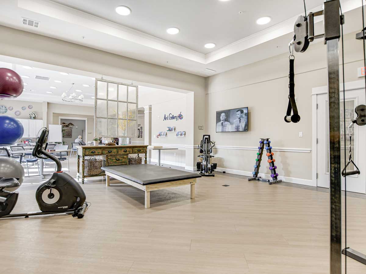 A spacious and well-equipped gym featuring modern fitness equipment and a clean, inviting atmosphere.