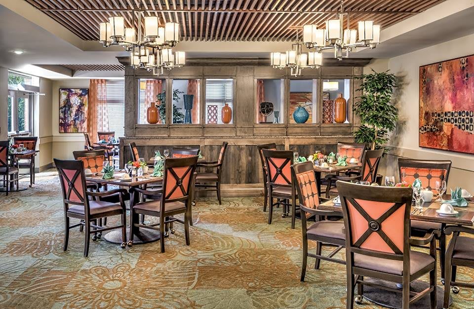 Elegant restaurant interior with beautifully arranged tables and chandeliers.