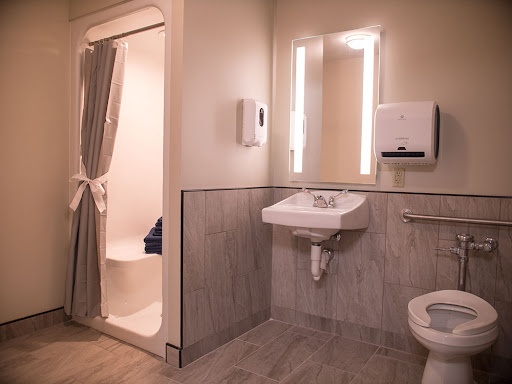 A modern and clean bathroom equipped with a sink, toilet, and shower.
