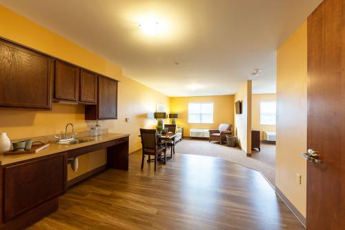 A spacious and well-lit apartment featuring a kitchen and dining area.