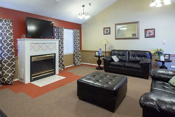 Cozy living room with a fireplace, television, and comfortable seating.