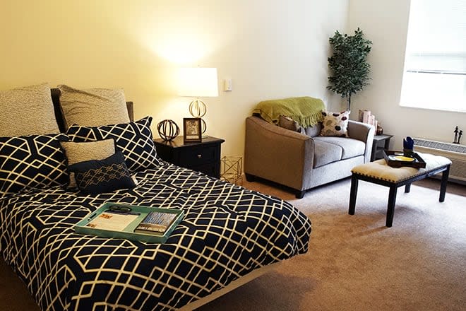 Cozy bedroom with modern decor and comfortable seating.