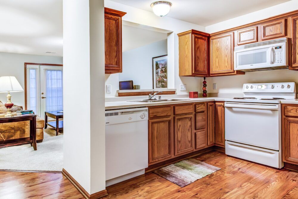 A cozy kitchen with wooden cabinets and white appliances.