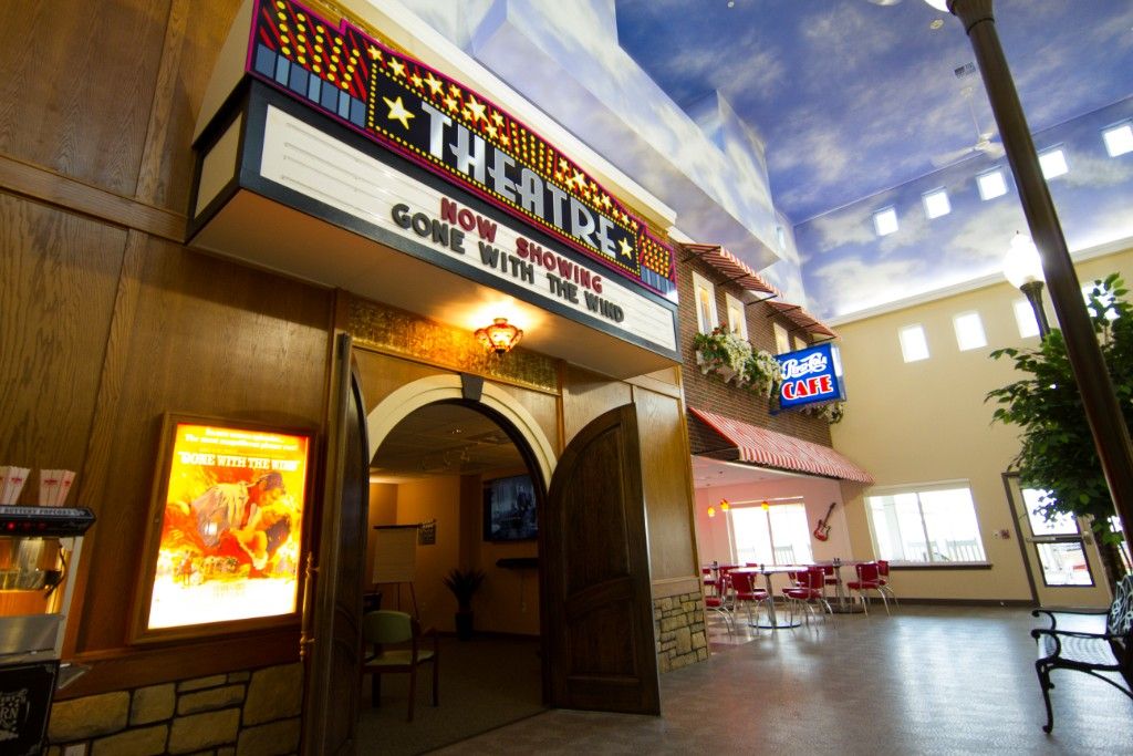 Entrance to a theater with a marquee displaying movie titles.