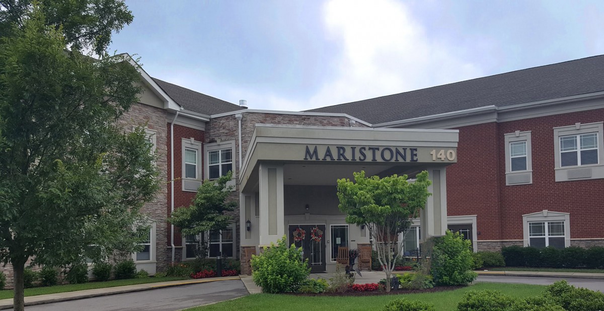 Front entrance of a residential building with well-maintained landscaping.