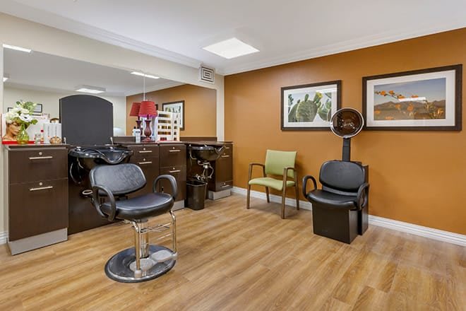 A well-organized hair salon interior with stylish chairs and modern decor.