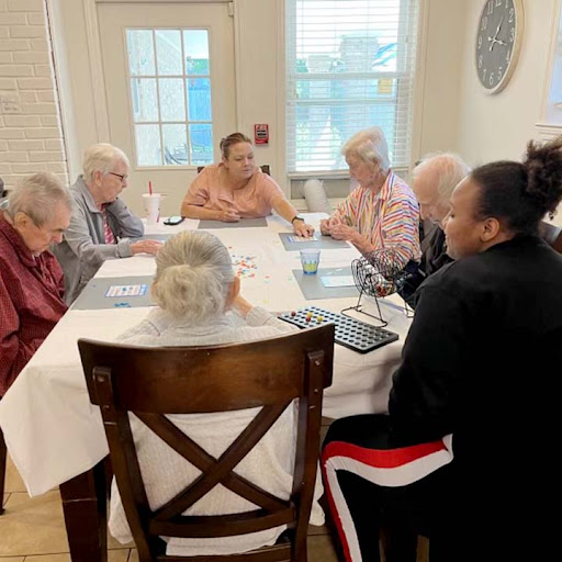 A group of seniors engaging in a lively discussion during a community activity.