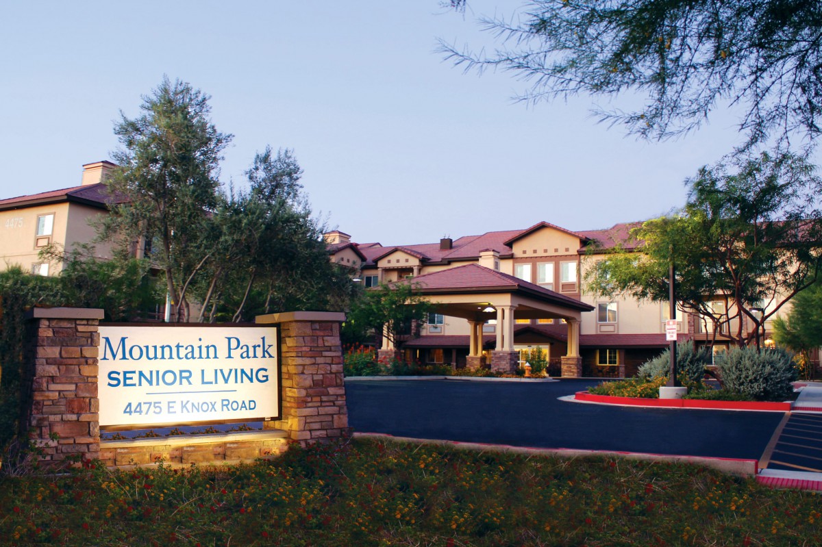 Entrance view of Mountain Park Senior Living facility with landscaped surroundings.