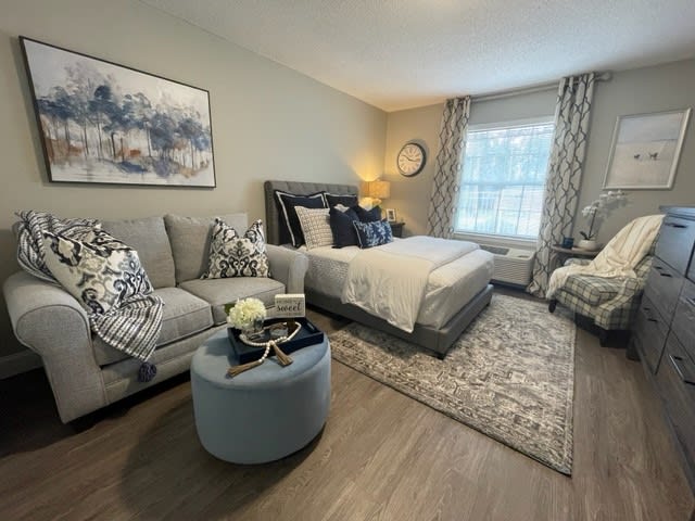 A modern and cozy bedroom featuring a comfortable bed, stylish sofa, and elegant decor.
