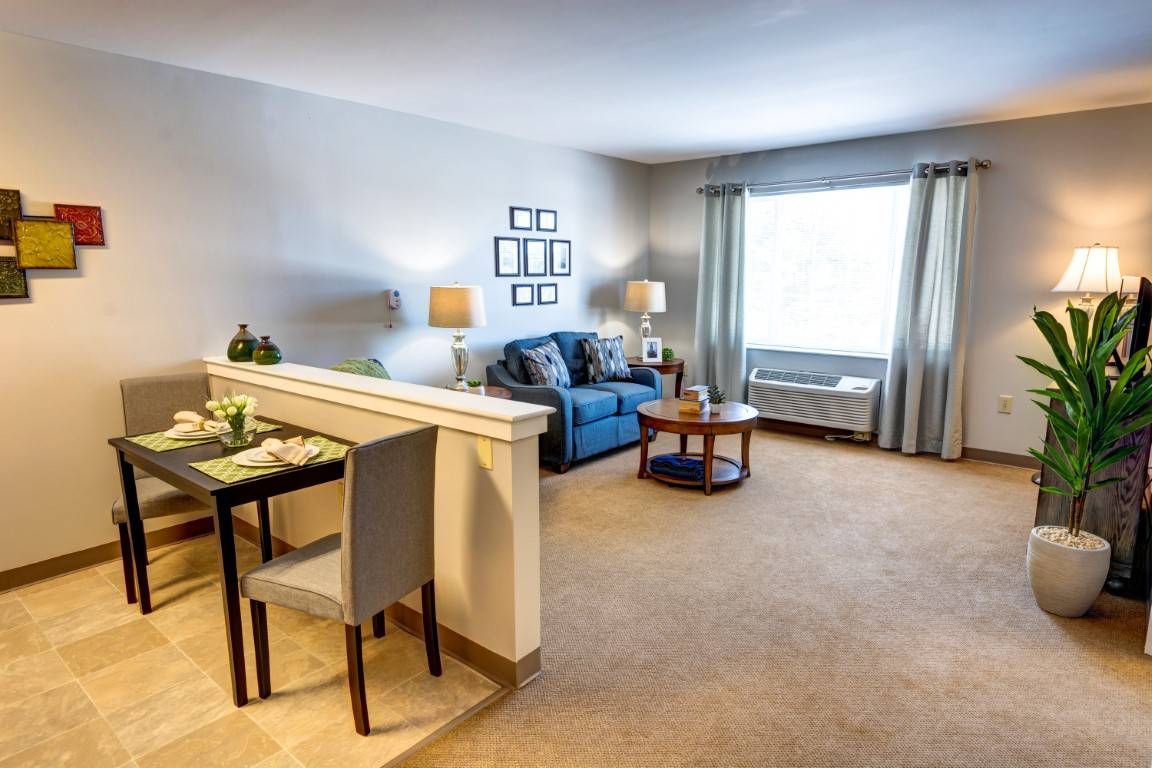 A cozy living room with a dining area, featuring comfortable seating and elegant decor.