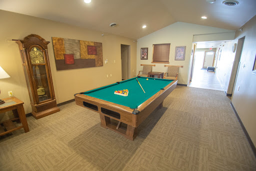 A cozy game room featuring a pool table, perfect for leisure and entertainment.