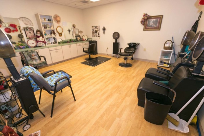 Interior view of a hair salon with chairs and hair styling equipment.