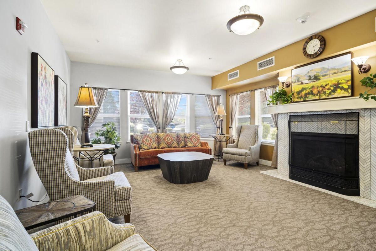 A cozy living room with comfortable seating and a fireplace.