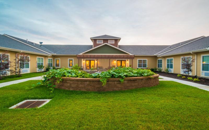 A beautiful building with a well-maintained garden and lawn.