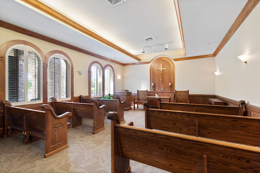 A serene courtroom interior featuring wooden benches and large windows.