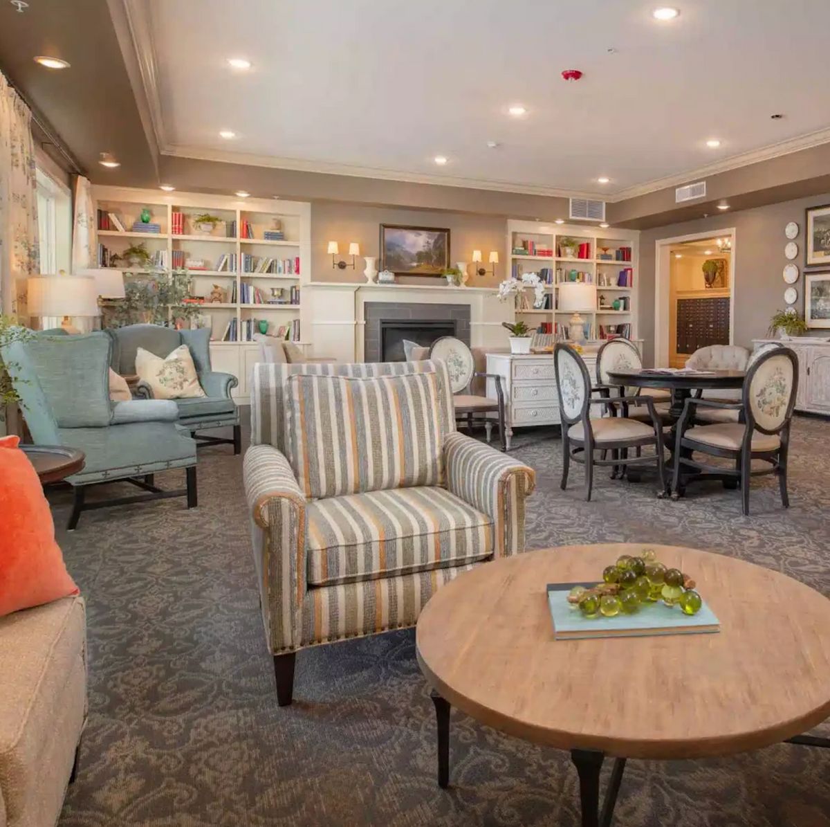A cozy, modern living room featuring comfortable seating, a fireplace, and stylish decor.