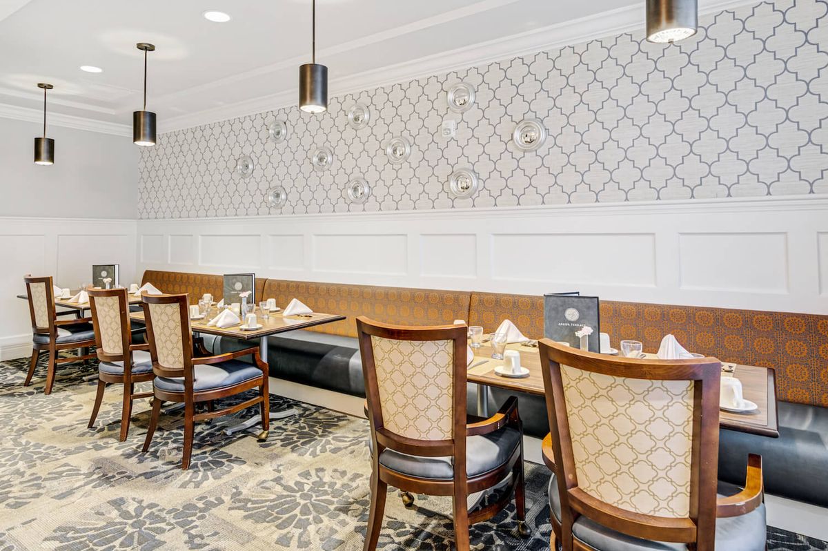 An elegant restaurant interior featuring neatly set tables and classic decor.