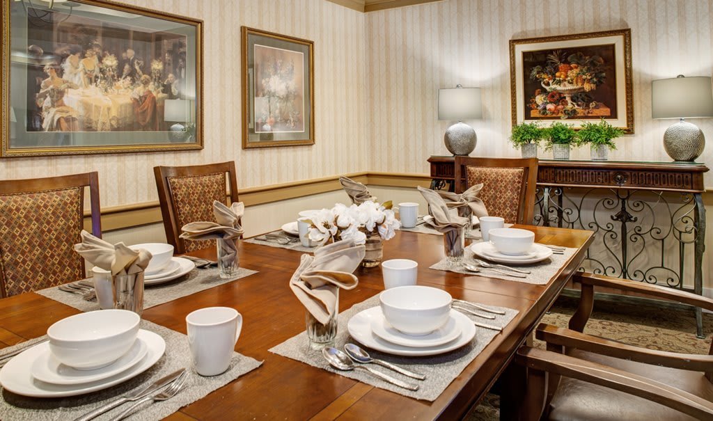 A well-decorated dining room with an elegantly set table.