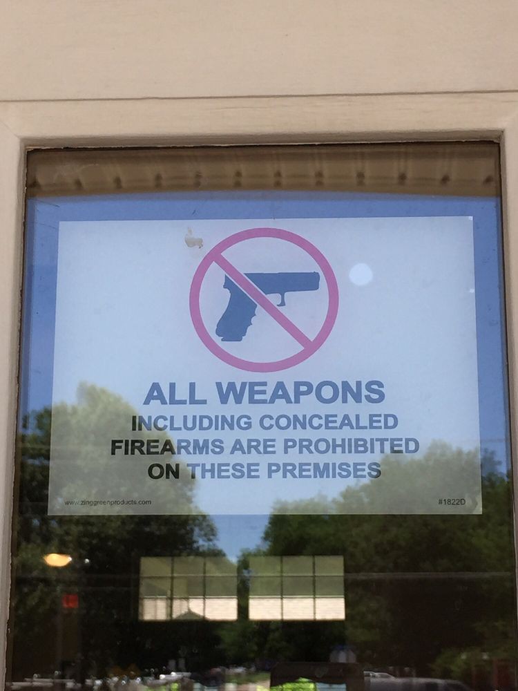 Sign prohibiting all weapons, including concealed firearms, on the premises.