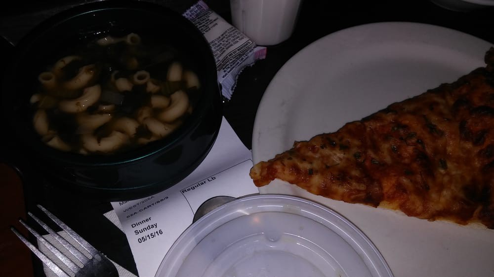 A meal consisting of a slice of pizza and a bowl of soup.