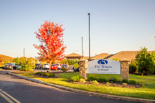 A beautiful autumn scene showcasing vibrant red foliage and a welcoming entrance to a residential community.
