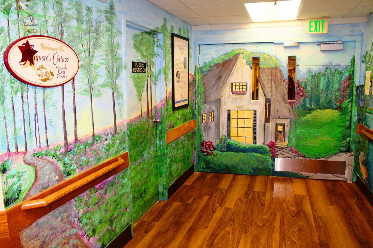 A hallway with a vibrant mural depicting a nature scene and a quaint house.