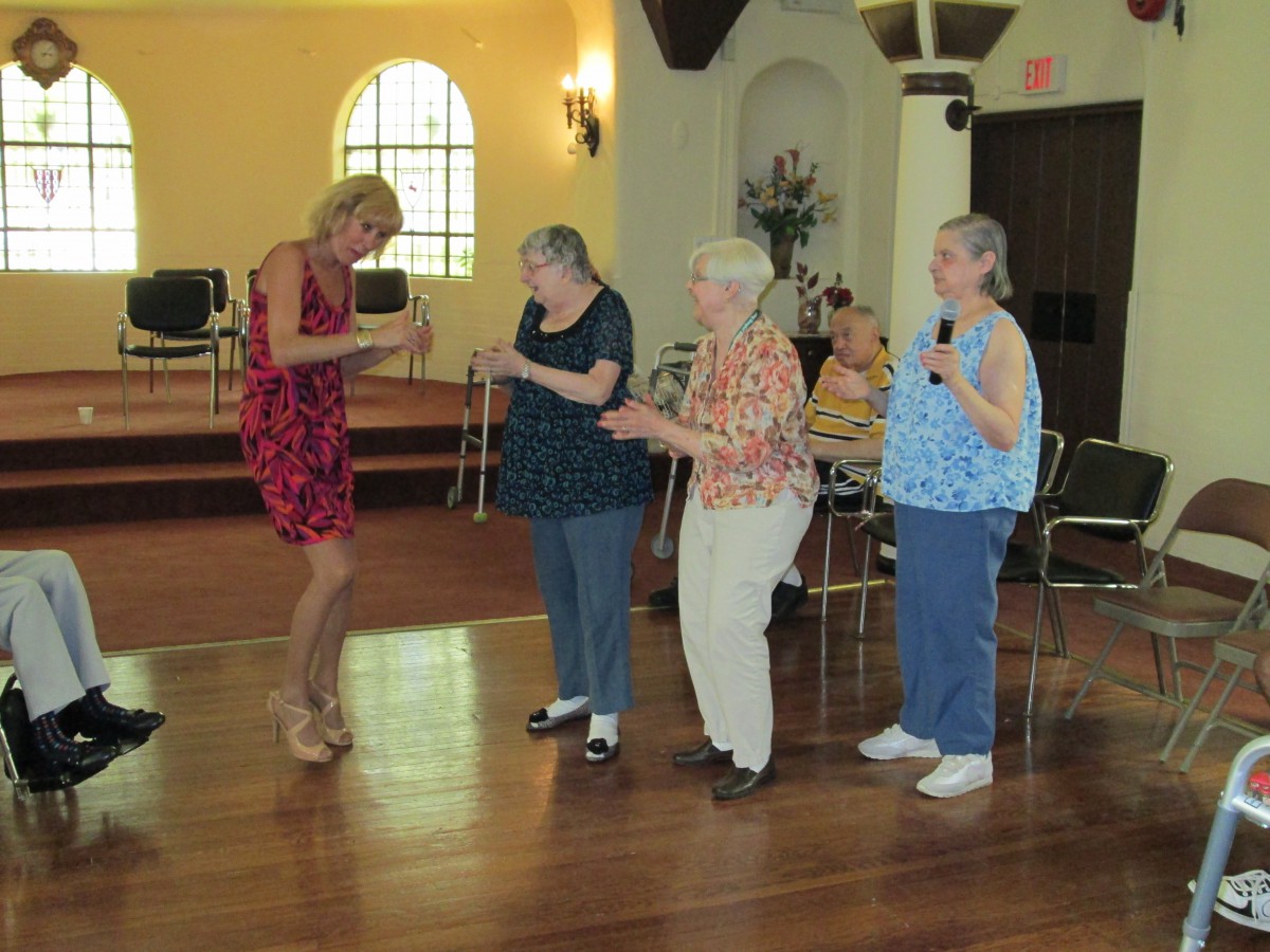A group of seniors enjoying a dance together in a community setting.