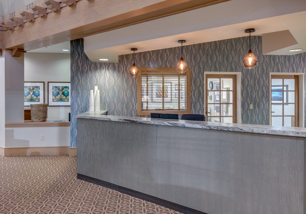 A modern office reception area with a stylish counter and decorative lighting.