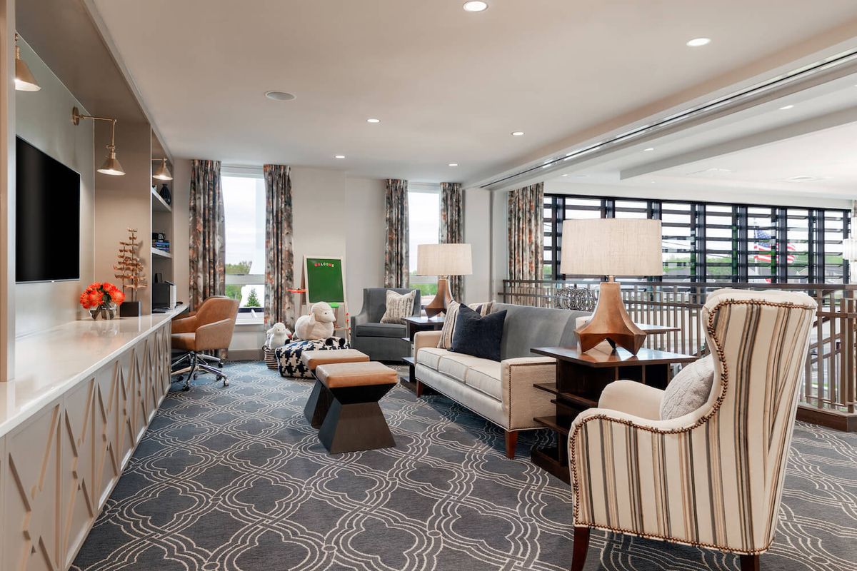 A spacious and well-designed living room featuring modern furniture and decor.