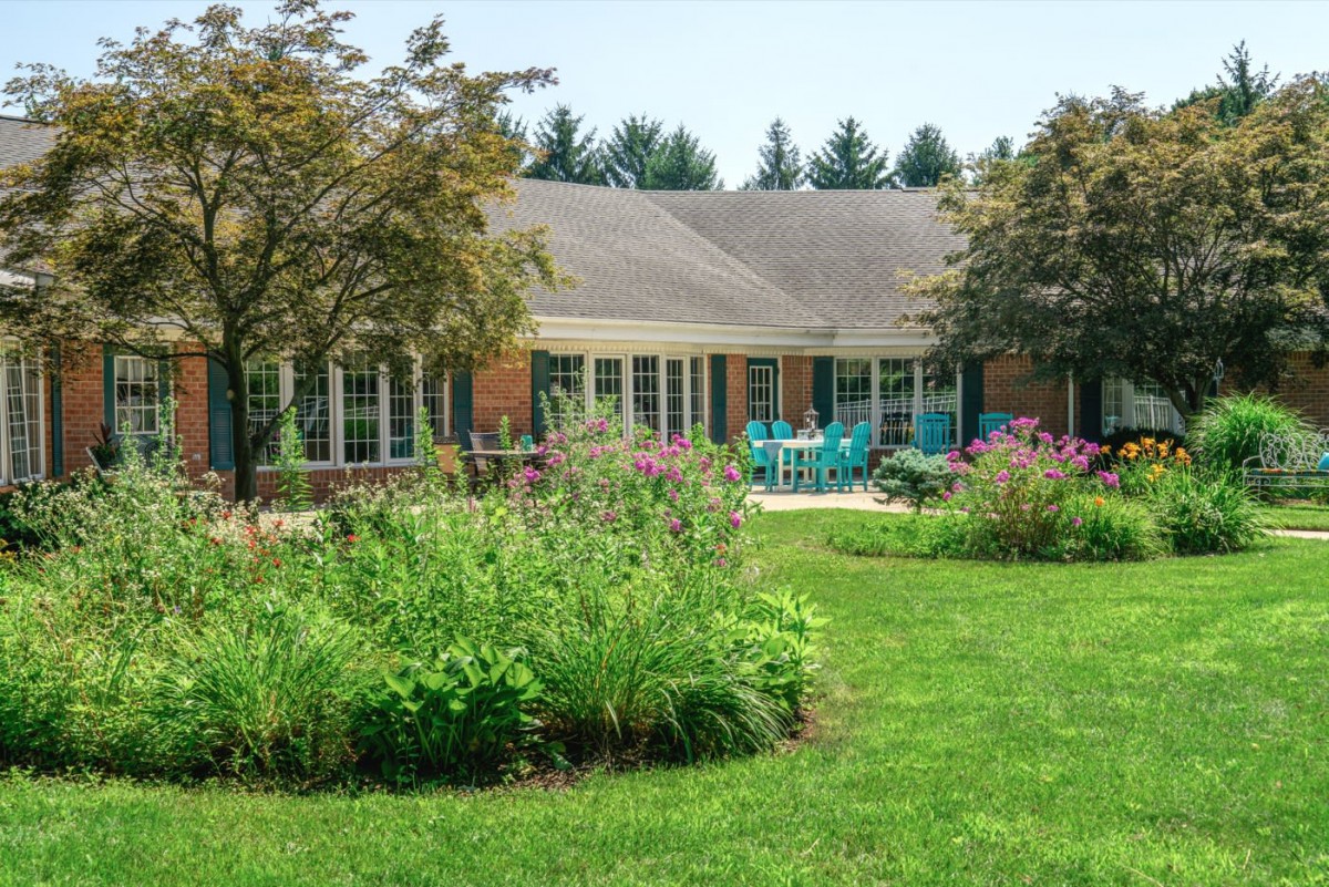 A cozy house with a well-maintained garden and patio area.