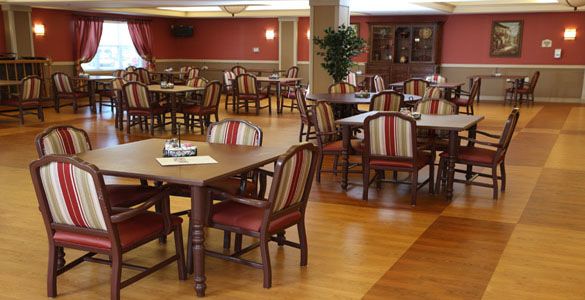 An empty dining room with neatly arranged tables and chairs.