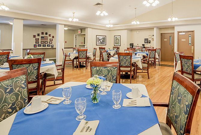 An elegantly set dining room with neatly arranged tables and chairs.