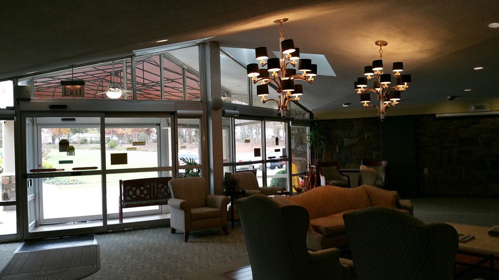 A cozy lobby interior with comfortable seating and elegant chandeliers.