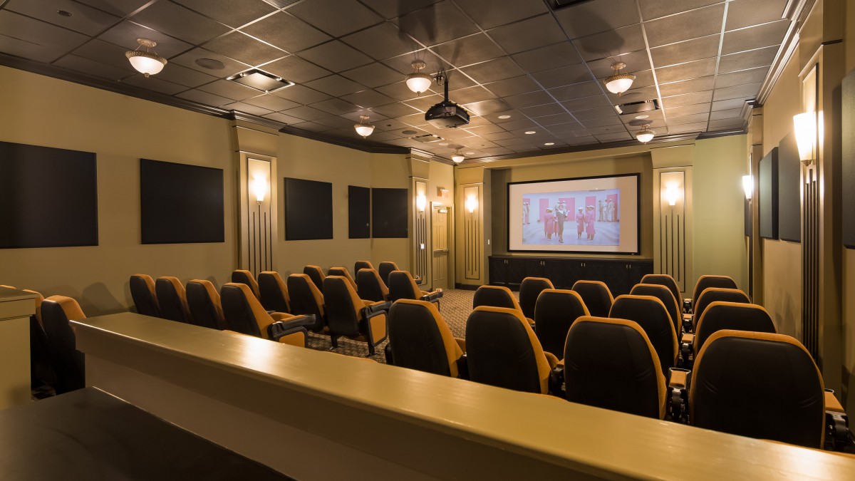 A cozy home theater setup with comfortable seating and a large screen.