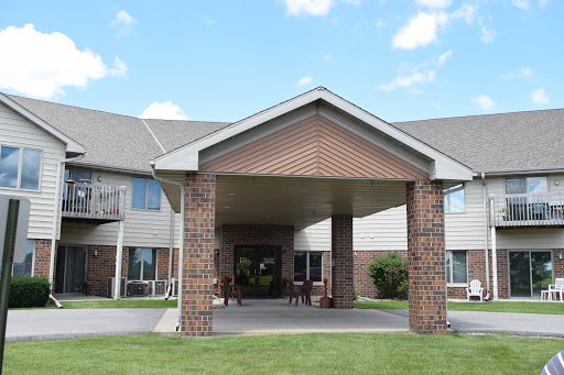 A welcoming entrance to a residential building under a clear blue sky.