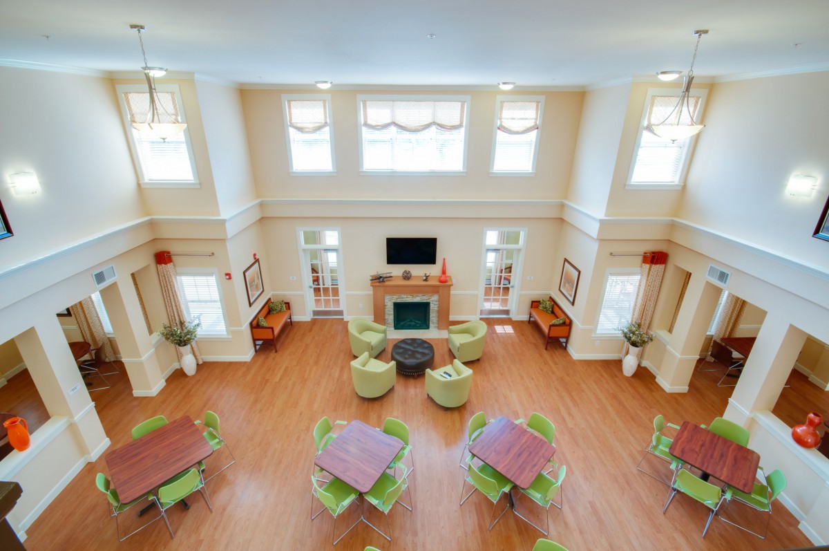 A spacious and elegant living room with seating arrangements and a fireplace.