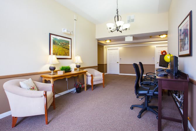 A spacious office interior with desks and computers arranged for work or meetings.