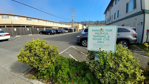 A view of a parking area with a sign indicating it is for Pacifica residents and rental cars only.