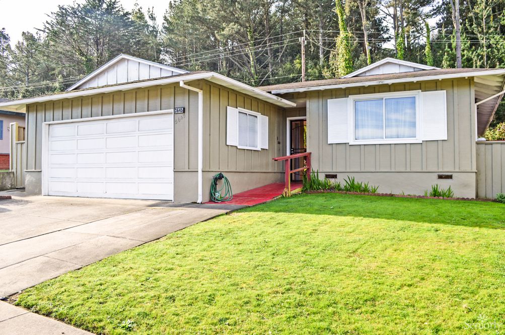 A single-story suburban house with a well-maintained lawn and attached garage.
