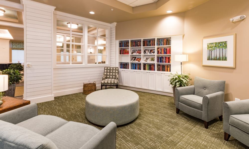 A cozy reading room with comfortable seating and bookshelves.