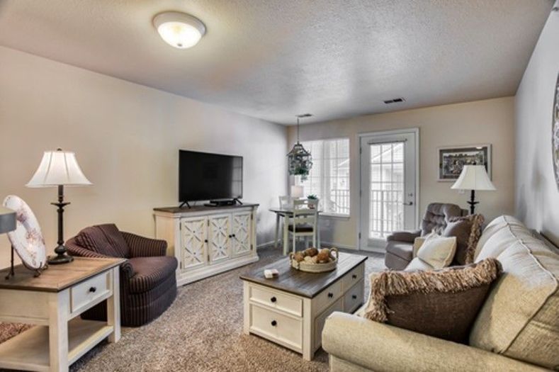 A cozy living room with a sofa, television, and coffee table.