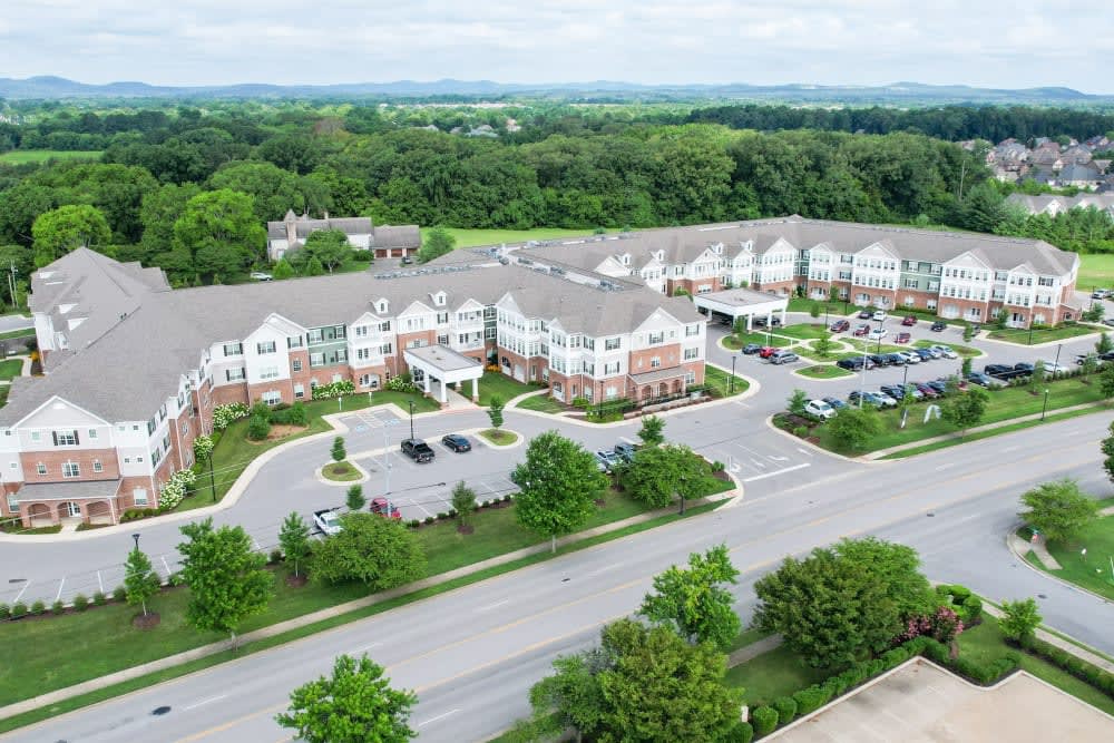 Aerial view of a suburban residential complex surrounded by trees and roads.
