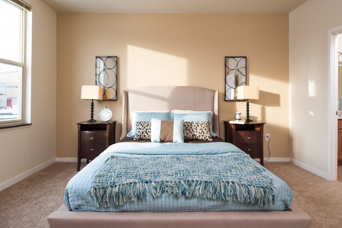 A well-decorated bedroom with modern furnishings and neutral tones.