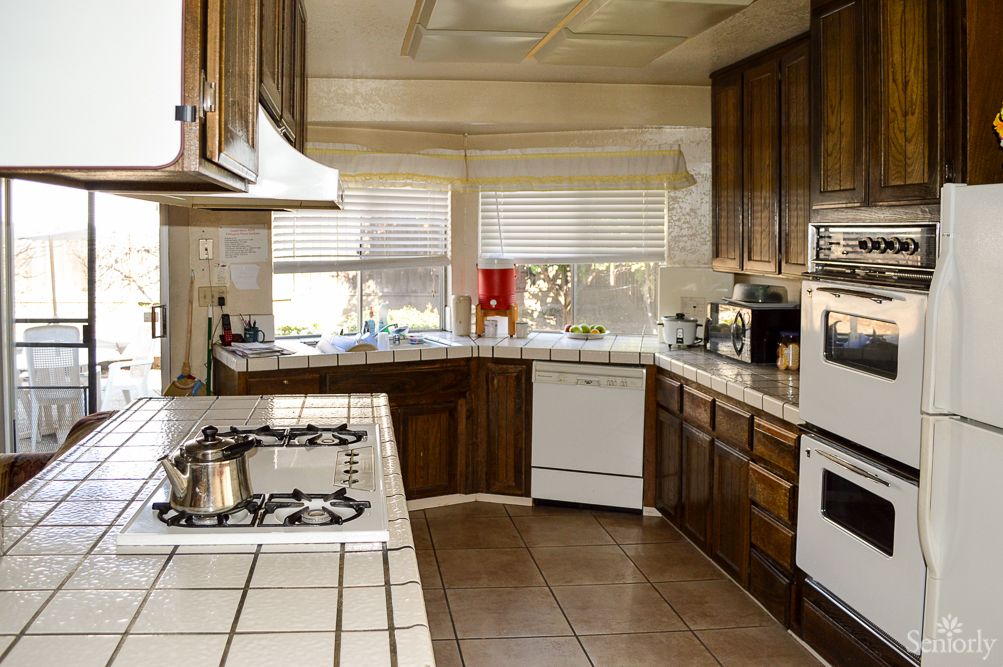 A spacious kitchen with wooden cabinets and modern appliances.