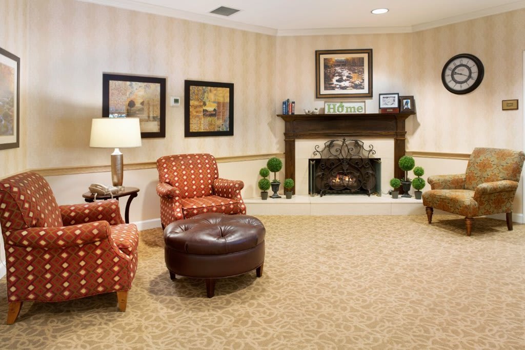 Cozy living room with armchairs and a fireplace.