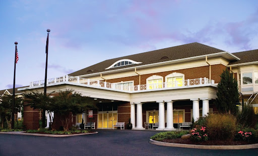 A charming hotel entrance showcasing classic architectural details and inviting landscaping.