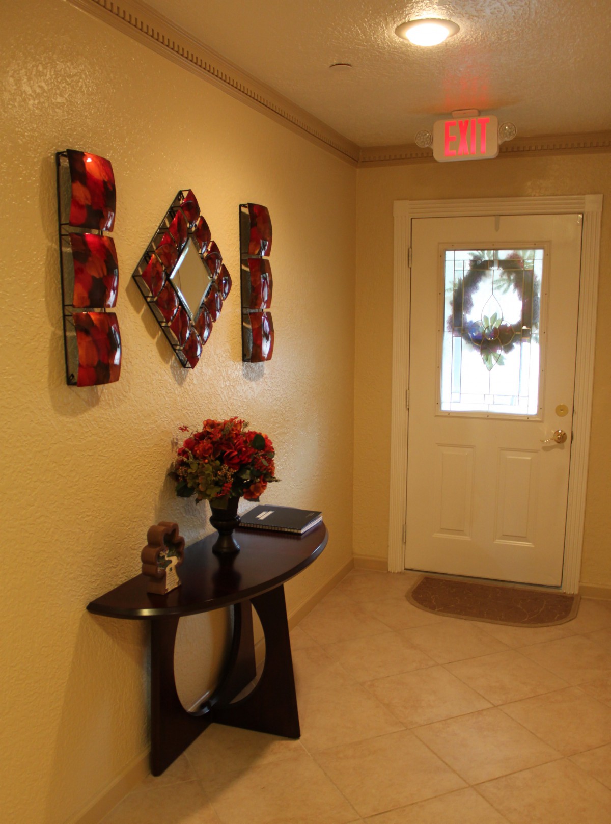 A warmly decorated entrance with holiday wreath and stylish wall art.