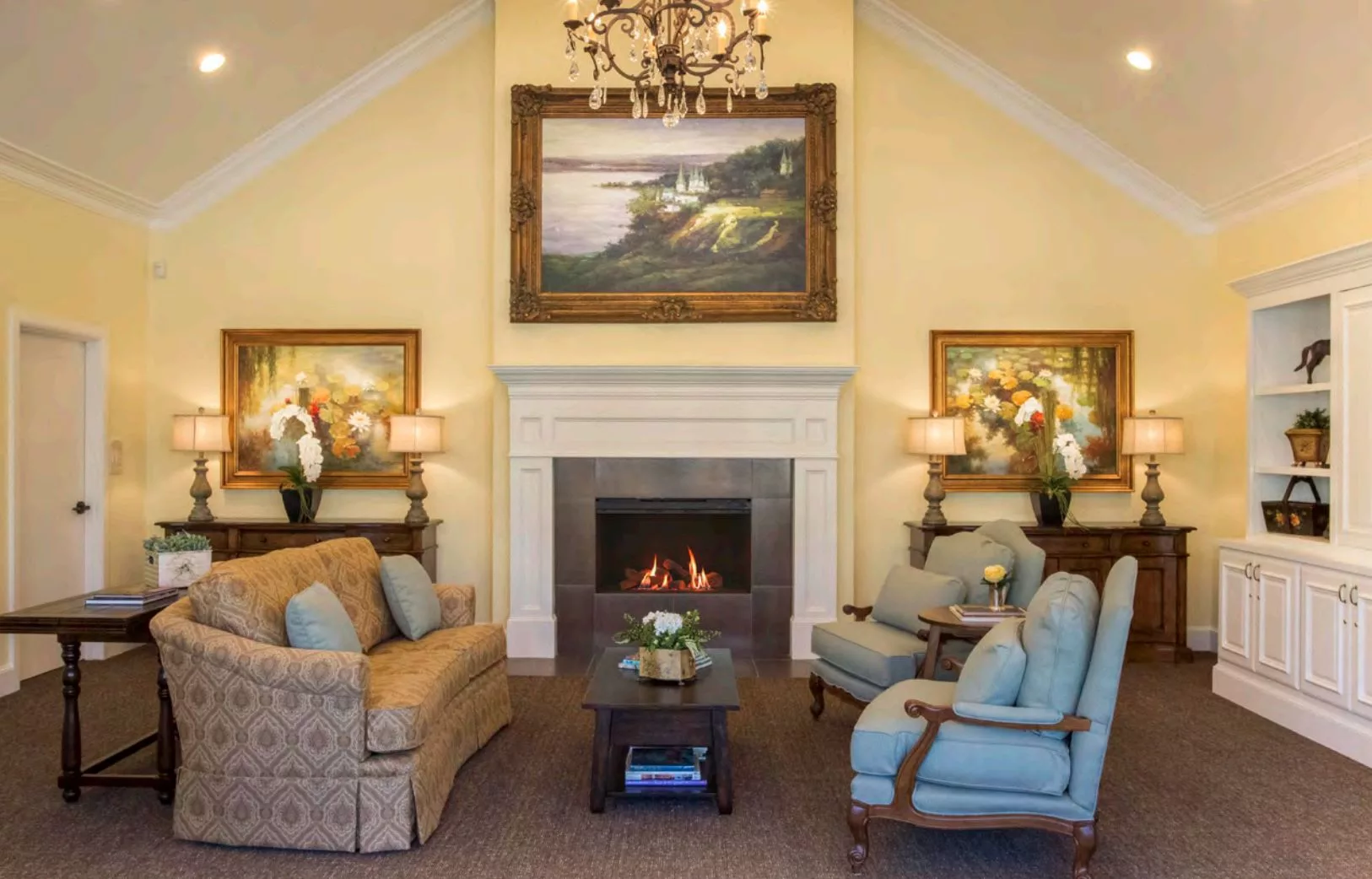 A cozy living room with a fireplace, elegant furniture, and decorative artwork.