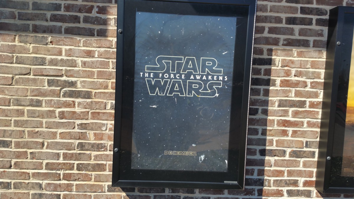 A movie poster for 'Star Wars: The Force Awakens' displayed in an outdoor frame.